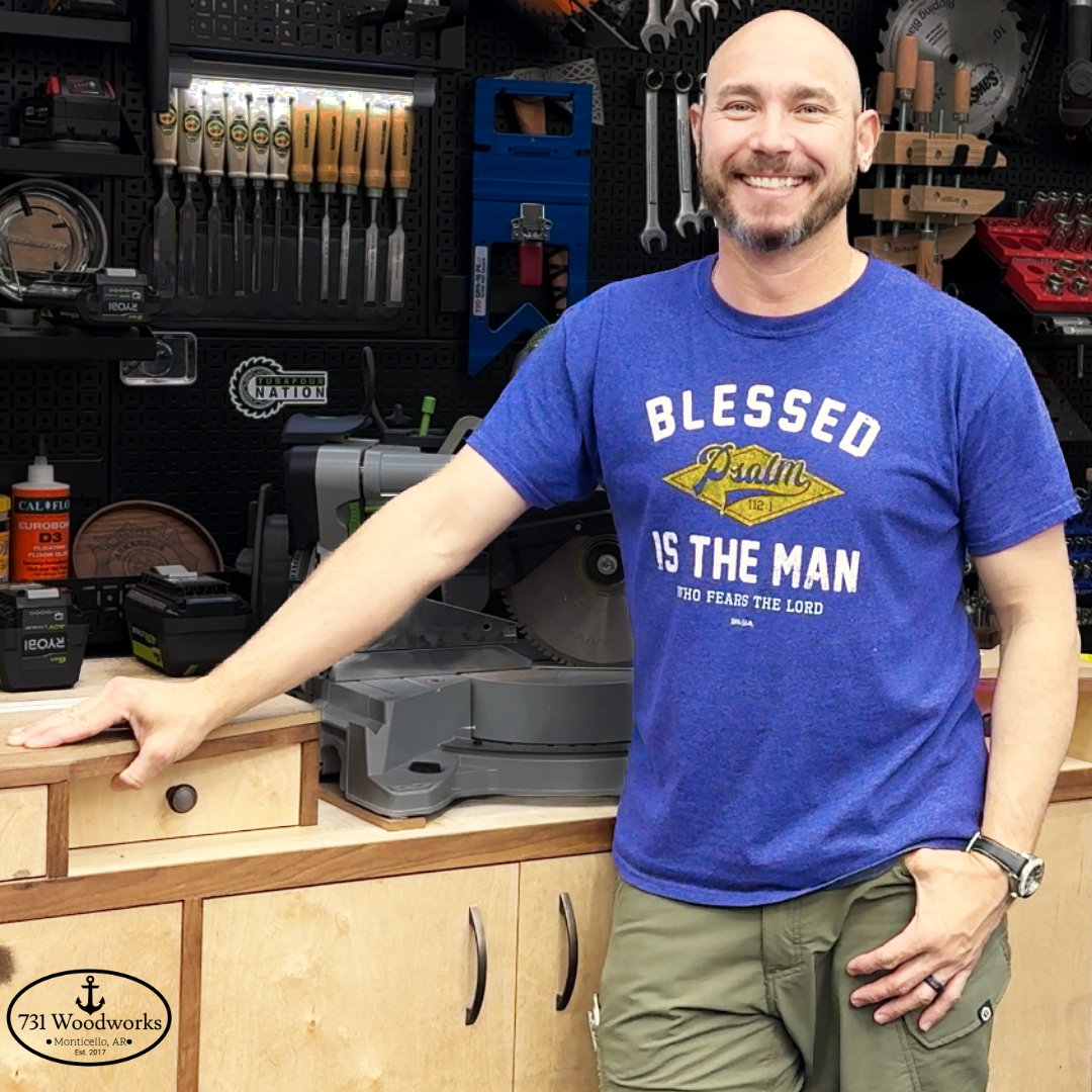 Matt Outlaw standing in front of power and hand tools, used for advertising charcuterie board kits.